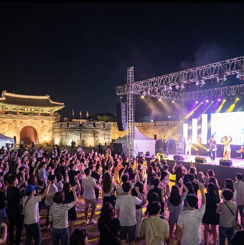 Suwon Tongdak Street Festival 2026 at Hwaseong Haenggung Plaza outdoor stage with evening illumination