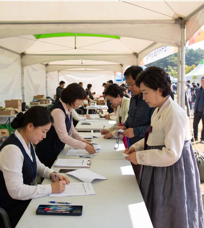 Pyeongchang Highland Kimjang Festival on-site food stall with pork bossam and dumpling soup served at wooden tables
